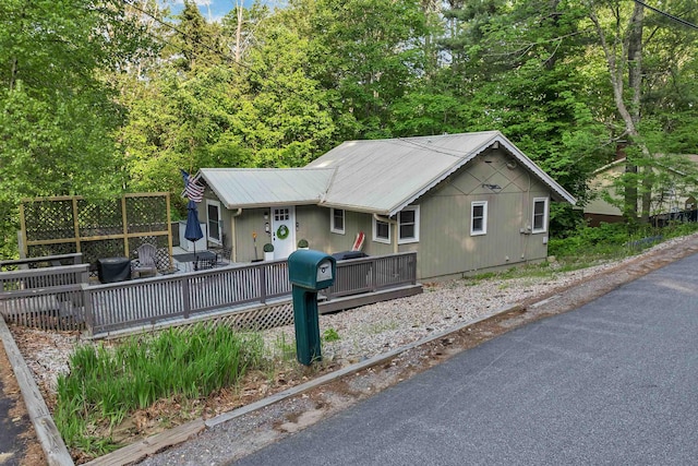 6 Chalet Dr, Gilford, NH 03249 - view of front of house featuring a wooden deck and metal roof