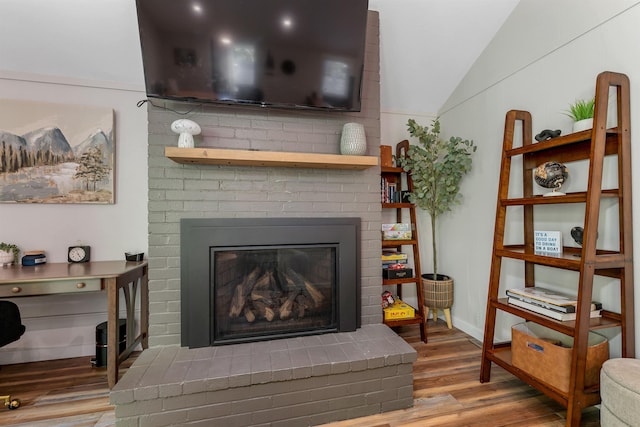 6 Chalet Dr, Gilford, NH 03249 - living room with wood finished floors, vaulted ceiling, and a brick fireplace