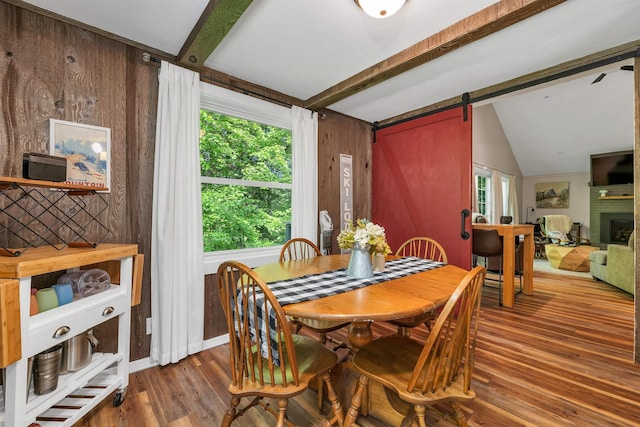 6 Chalet Dr, Gilford, NH 03249 - dining area with wood finished floors, a barn door, a fireplace, and wooden walls