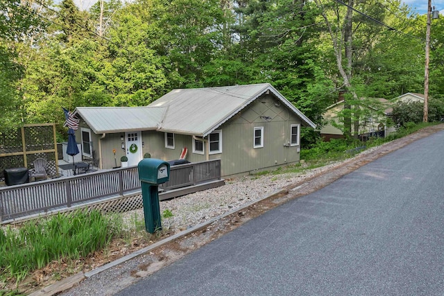 6 Chalet Dr, Gilford, NH 03249 - view of front of house with a wooden deck and metal roof