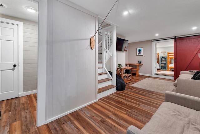 6 Chalet Dr, Gilford, NH 03249 - living area featuring stairs, a barn door, wood finished floors, baseboards, and recessed lighting