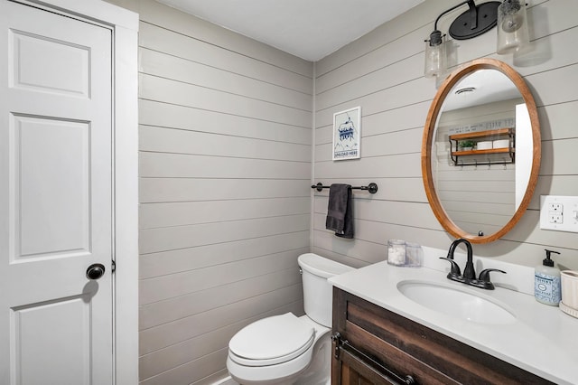 6 Chalet Dr, Gilford, NH 03249 - half bathroom with vanity, toilet, and wooden walls