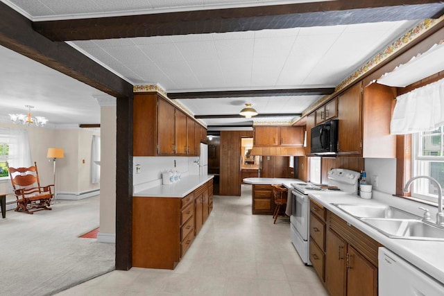 3 Patton St, Rochester, NH 03867 - kitchen featuring white appliances, a sink, brown cabinets, and a chandelier