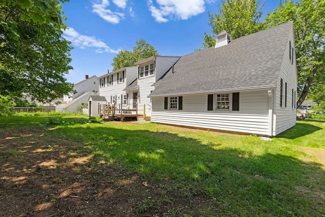 3 Patton St, Rochester, NH 03867 - rear view of property featuring a chimney, roof with shingles, and a deck