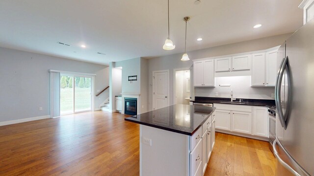 5 Callaway Dr Unit 2, Concord, NH 03301 - kitchen with appliances with stainless steel finishes, a sink, dark countertops, open floor plan, and recessed lighting