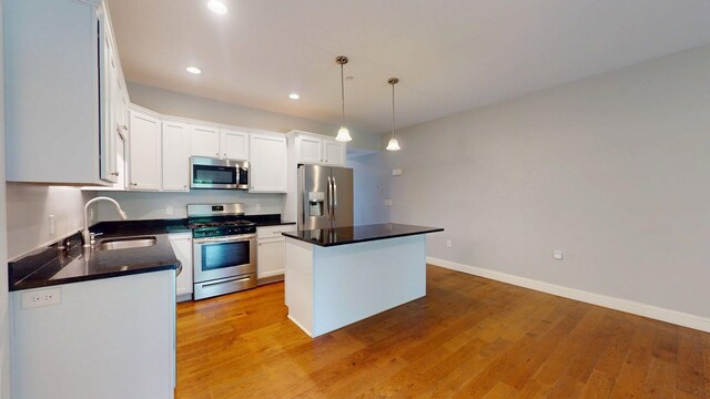 5 Callaway Dr Unit 2, Concord, NH 03301 - kitchen featuring appliances with stainless steel finishes, a sink, a center island, white cabinets, and light wood finished floors