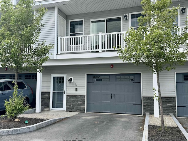5 Callaway Dr Unit 2, Concord, NH 03301 - view of front of home featuring stone siding, a balcony, and a garage