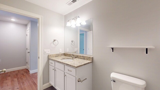 5 Callaway Dr Unit 2, Concord, NH 03301 - bathroom featuring wood finished floors, vanity, toilet, and baseboards