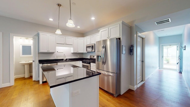 5 Callaway Dr Unit 2, Concord, NH 03301 - kitchen with appliances with stainless steel finishes, light wood-type flooring, a sink, baseboards, and recessed lighting