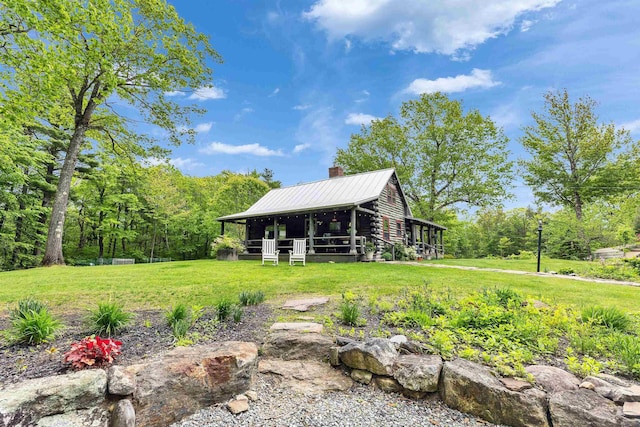 92 Brown Rd, Temple, NH 03084 - view of front facade with a chimney, metal roof, a front lawn, log siding, and an outbuilding