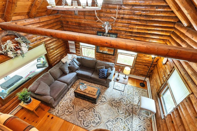 92 Brown Rd, Temple, NH 03084 - living area with rustic walls, wood-type flooring, high vaulted ceiling, beamed ceiling, and a baseboard heating unit