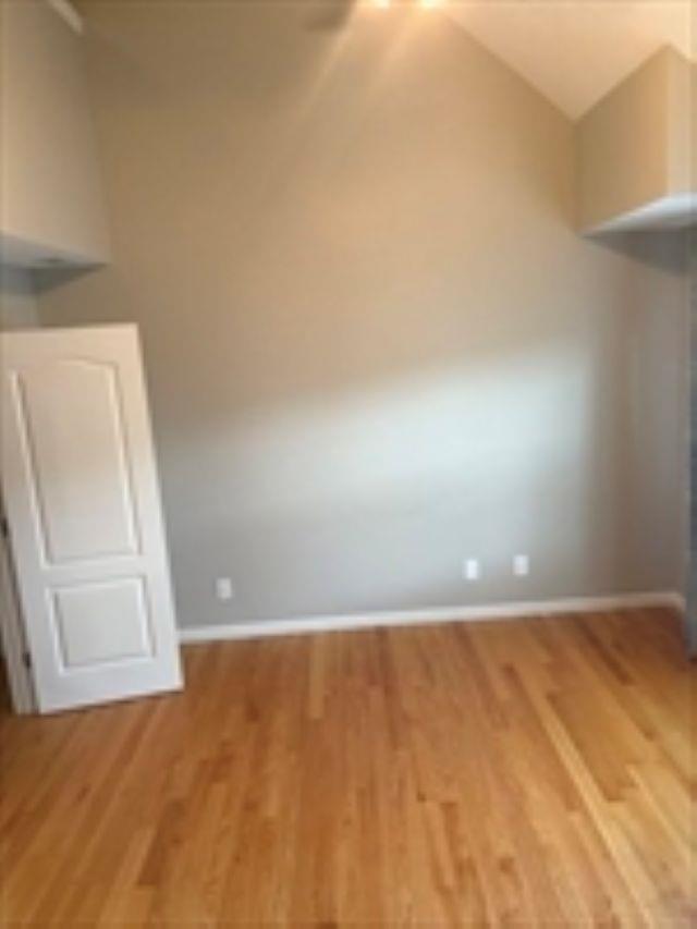 24 Bandon Cir, Westford, MA 01886 - spare room with light wood-style floors, baseboards, and vaulted ceiling