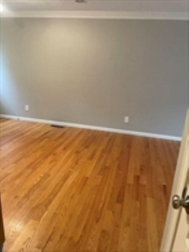 24 Bandon Cir, Westford, MA 01886 - spare room with crown molding, light wood-style floors, and baseboards