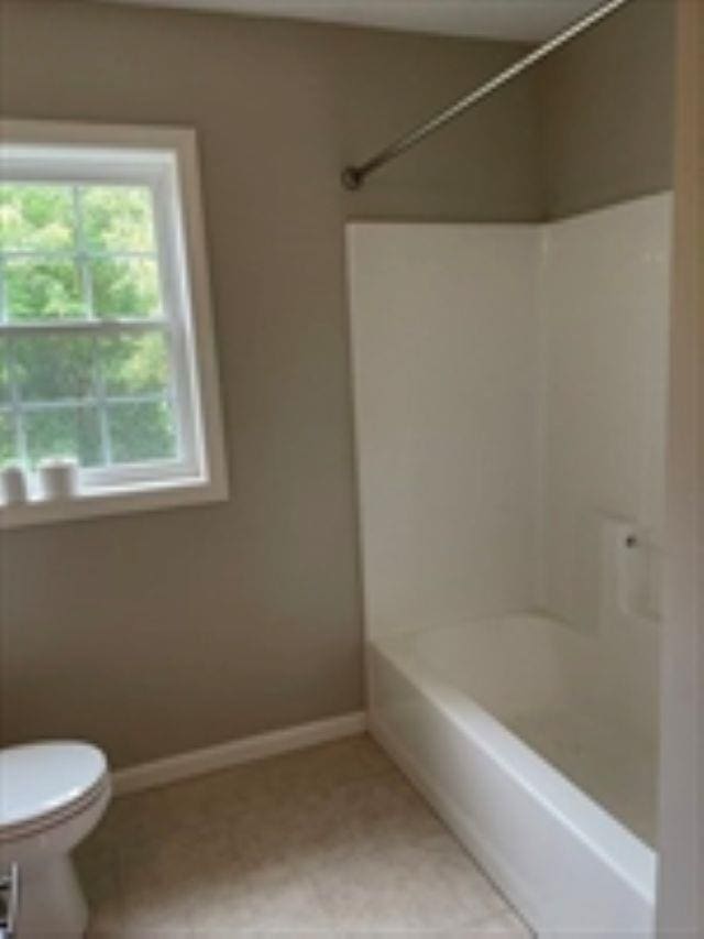 24 Bandon Cir, Westford, MA 01886 - full bathroom with toilet, washtub / shower combination, tile patterned flooring, and baseboards