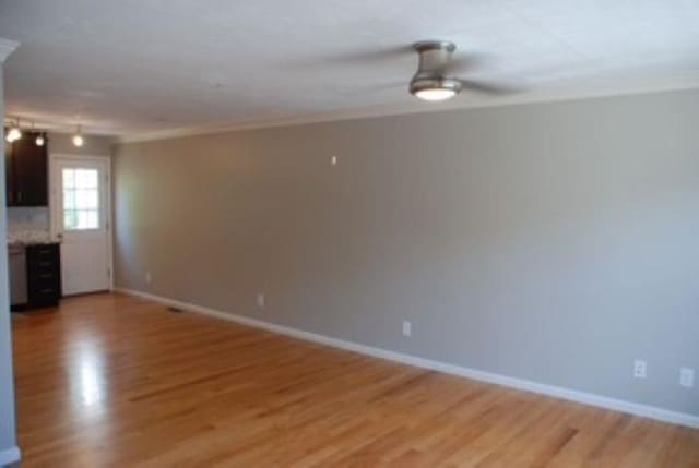 24 Bandon Cir, Westford, MA 01886 - unfurnished living room featuring light wood-style floors, a ceiling fan, and baseboards