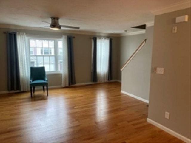 24 Bandon Cir, Westford, MA 01886 - unfurnished room featuring crown molding, baseboards, wood finished floors, and ceiling fan