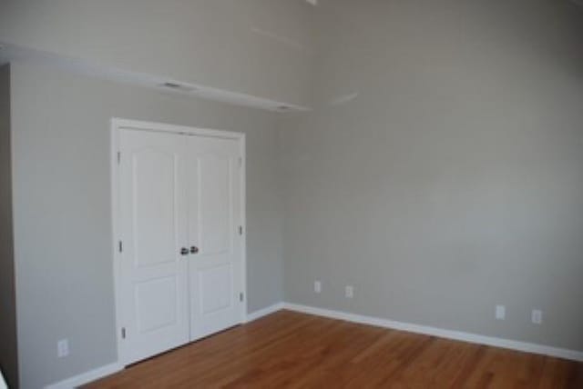 24 Bandon Cir, Westford, MA 01886 - unfurnished bedroom featuring wood finished floors, baseboards, and a closet