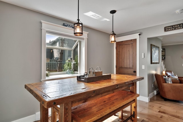60 Weirs Rd Unit H1, Gilford, NH 03249 - dining room with baseboards, light wood finished floors, and ornamental molding