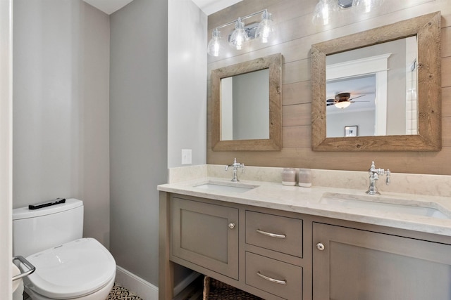 60 Weirs Rd Unit H1, Gilford, NH 03249 - bathroom with double vanity, toilet, ceiling fan, and baseboards