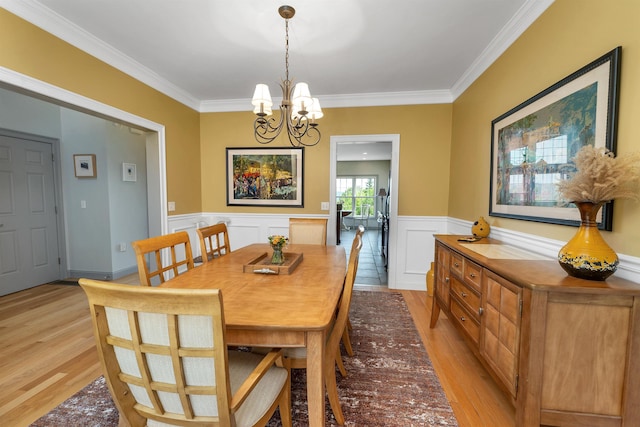 4 Mountain Ridge Dr, Meredith, NH 03253 - dining room with light wood-style flooring, a chandelier, crown molding, and a wainscoted wall