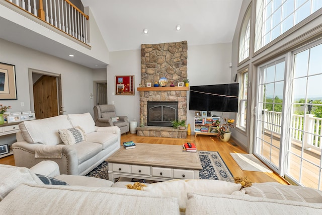 4 Mountain Ridge Dr, Meredith, NH 03253 - living area featuring high vaulted ceiling, wood finished floors, and a fireplace