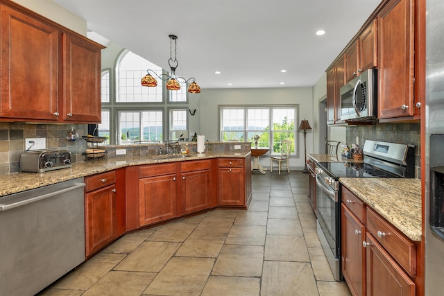 4 Mountain Ridge Dr, Meredith, NH 03253 - kitchen with stainless steel appliances, decorative backsplash, a peninsula, a sink, and recessed lighting