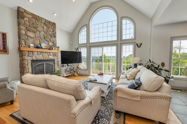 4 Mountain Ridge Dr, Meredith, NH 03253 - living room featuring a stone fireplace and high vaulted ceiling