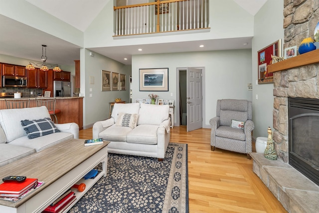 4 Mountain Ridge Dr, Meredith, NH 03253 - living area featuring a fireplace, light wood finished floors, high vaulted ceiling, recessed lighting, and baseboards