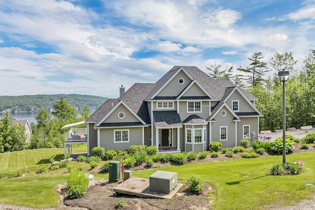 4 Mountain Ridge Dr, Meredith, NH 03253 - view of front of house with a chimney, a front lawn, and roof with shingles