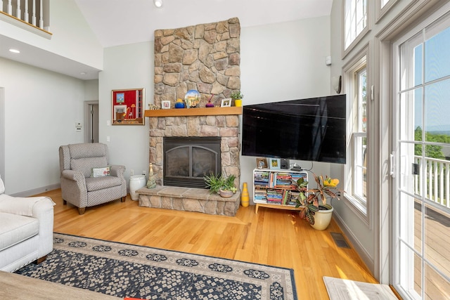 4 Mountain Ridge Dr, Meredith, NH 03253 - living room with wood finished floors, healthy amount of natural light, baseboards, and vaulted ceiling