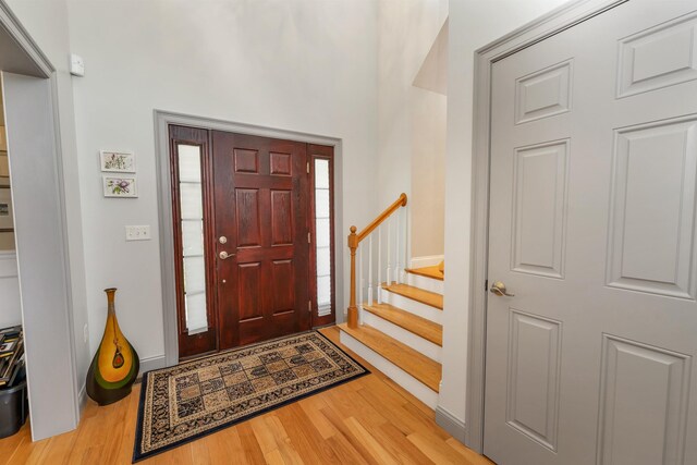 4 Mountain Ridge Dr, Meredith, NH 03253 - foyer entrance with wood finished floors, stairway, and baseboards