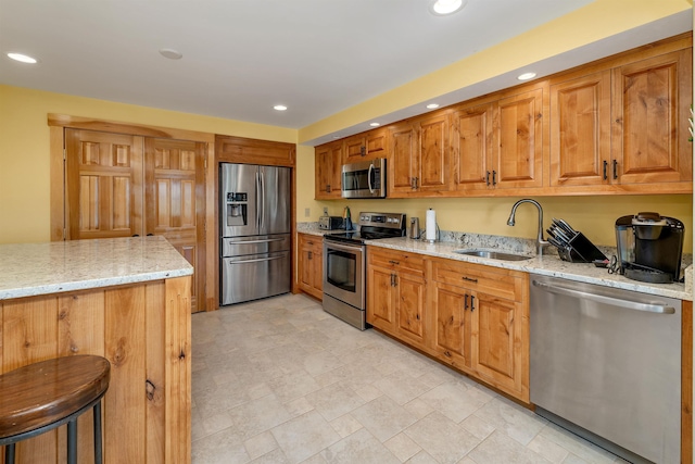 4 Mountain Ridge Dr, Meredith, NH 03253 - kitchen featuring stainless steel appliances, a sink, light stone countertops, recessed lighting, and brown cabinetry