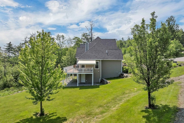 4 Mountain Ridge Dr, Meredith, NH 03253 - back of property featuring a wooden deck, a yard, a chimney, and roof with shingles