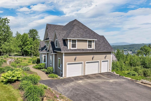 4 Mountain Ridge Dr, Meredith, NH 03253 - view of home's exterior with asphalt driveway and roof with shingles