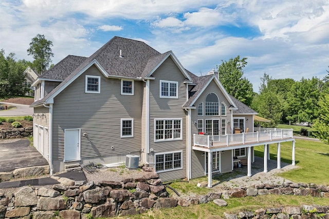 4 Mountain Ridge Dr, Meredith, NH 03253 - rear view of property with central AC, a wooden deck, a chimney, a garage, and roof with shingles
