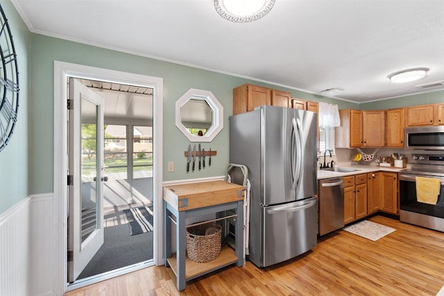 45 Cohas Ave, Manchester, NH 03109 - kitchen with stainless steel appliances, a sink, light wood-style flooring, light countertops, and ornamental molding