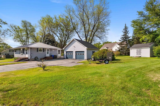 45 Cohas Ave, Manchester, NH 03109 - view of front facade with an outbuilding, a garage, and a front yard
