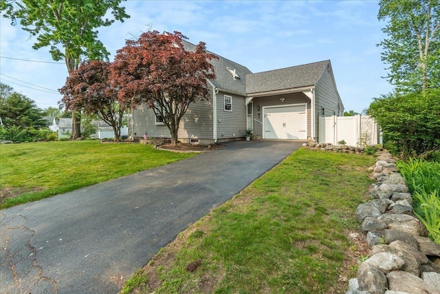 85 Lee Ave, Manchester, NH 03109 - view of front facade with asphalt driveway, an attached garage, and a shingled roof