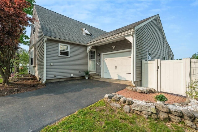 85 Lee Ave, Manchester, NH 03109 - view of property exterior featuring a garage, roof with shingles, asphalt driveway, and entry steps