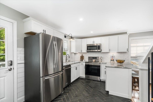 85 Lee Ave, Manchester, NH 03109 - kitchen with stainless steel appliances, plenty of natural light, a sink, backsplash, and recessed lighting