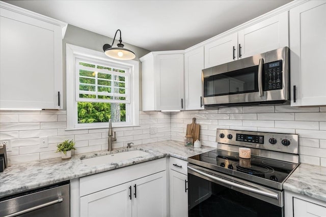 85 Lee Ave, Manchester, NH 03109 - kitchen with stainless steel appliances, a sink, tasteful backsplash, and white cabinets