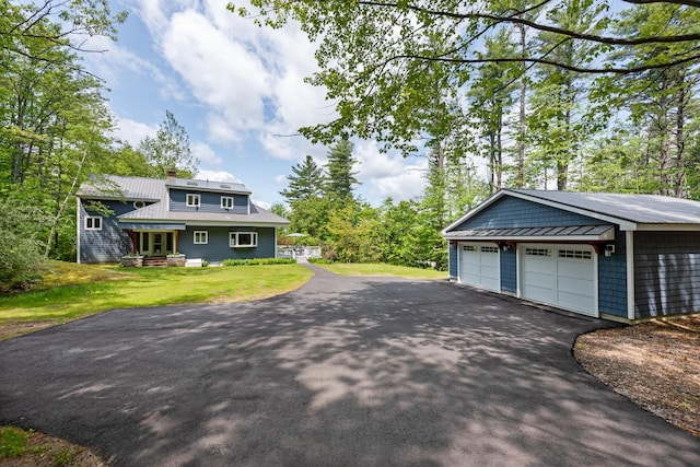 110 Heights Rd, Gilford, NH 03249 - view of home's exterior with metal roof, a lawn, an outbuilding, a chimney, and a standing seam roof