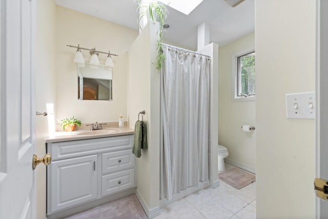 110 Heights Rd, Gilford, NH 03249 - bathroom featuring tile patterned floors, vanity, toilet, and a skylight