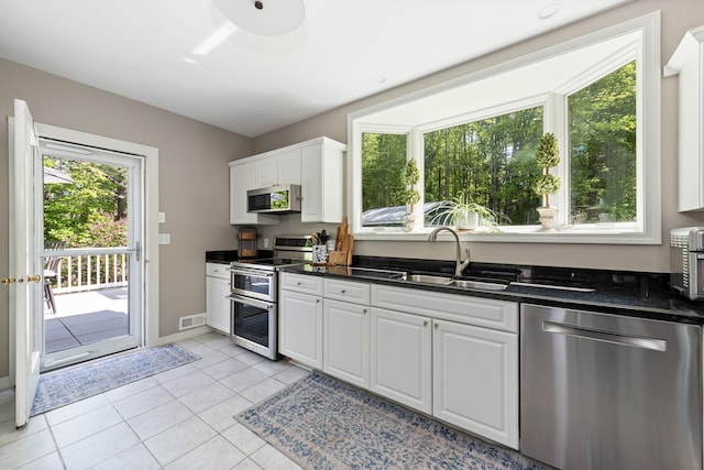 110 Heights Rd, Gilford, NH 03249 - kitchen featuring appliances with stainless steel finishes, a sink, dark countertops, and white cabinetry