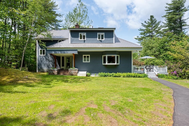 110 Heights Rd, Gilford, NH 03249 - view of front facade featuring a chimney, a front lawn, and metal roof