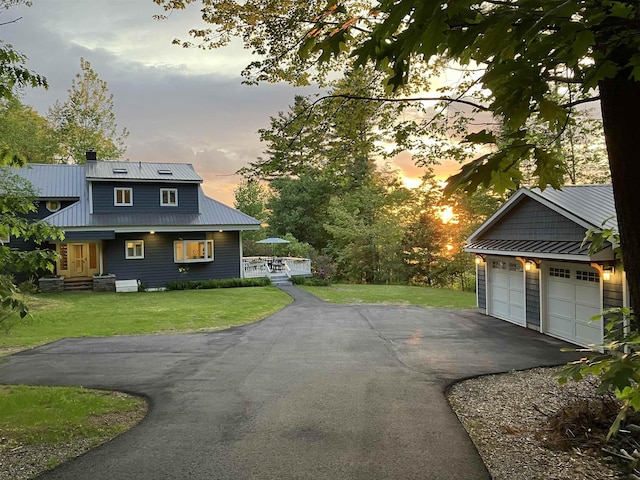 110 Heights Rd, Gilford, NH 03249 - view of front of house featuring metal roof, driveway, a front lawn, and a chimney