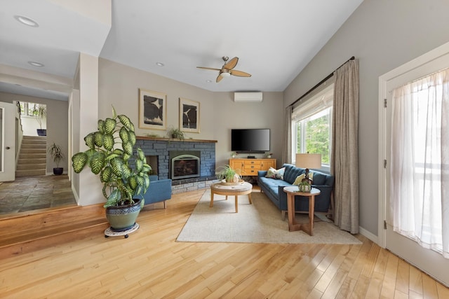 110 Heights Rd, Gilford, NH 03249 - living room featuring ceiling fan, a wall mounted AC, stairway, wood finished floors, and a fireplace