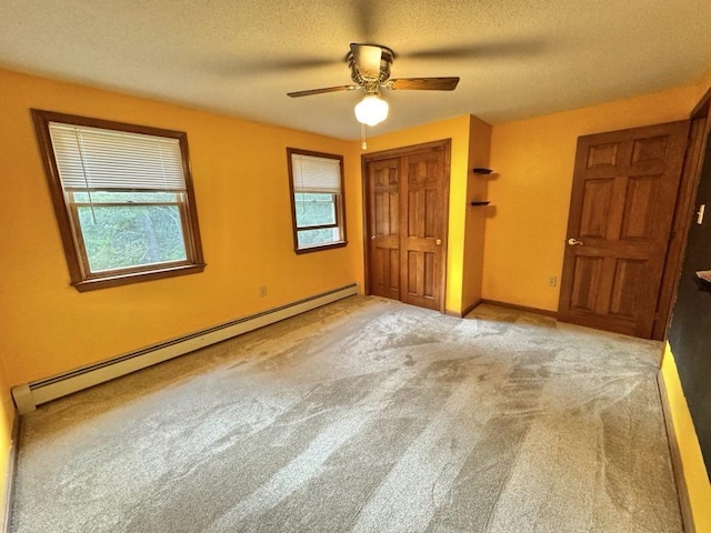 93 Faith Dr, Hampstead, NH 03841 - unfurnished bedroom with a baseboard heating unit, a textured ceiling, carpet floors, a closet, and a ceiling fan