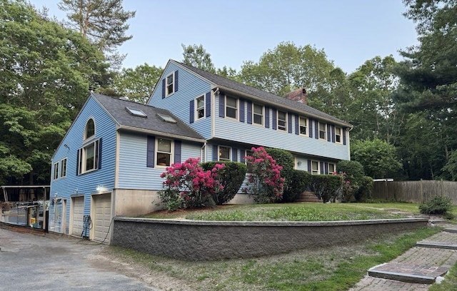 93 Faith Dr, Hampstead, NH 03841 - colonial-style house featuring a garage, a chimney, and asphalt driveway
