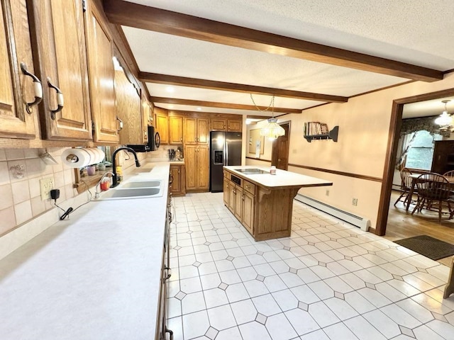 93 Faith Dr, Hampstead, NH 03841 - kitchen with a sink, a baseboard heating unit, stainless steel fridge, beam ceiling, and brown cabinets